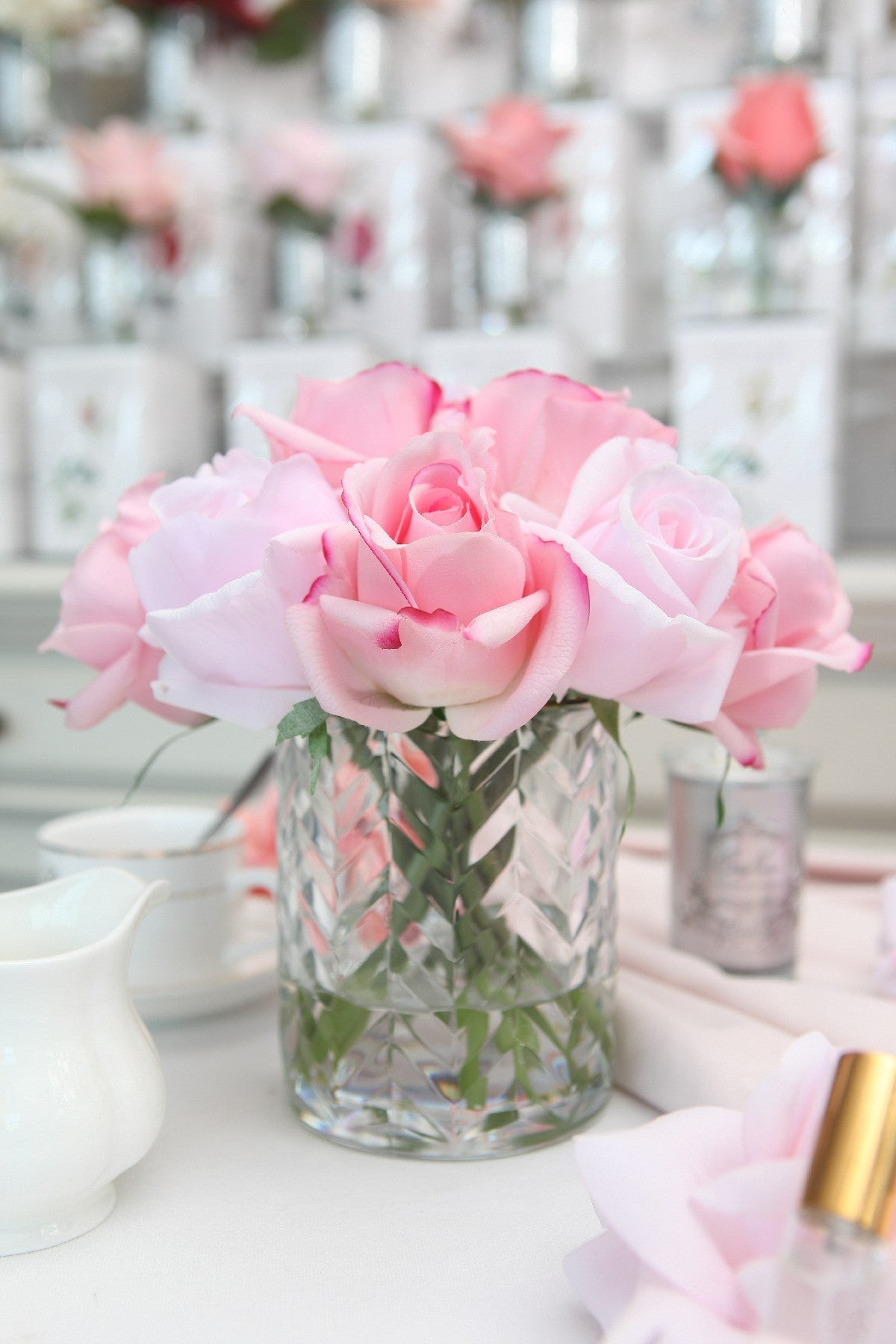 Cote Noire herringbone flower in clear glass with mixed pink rose buds, detail view