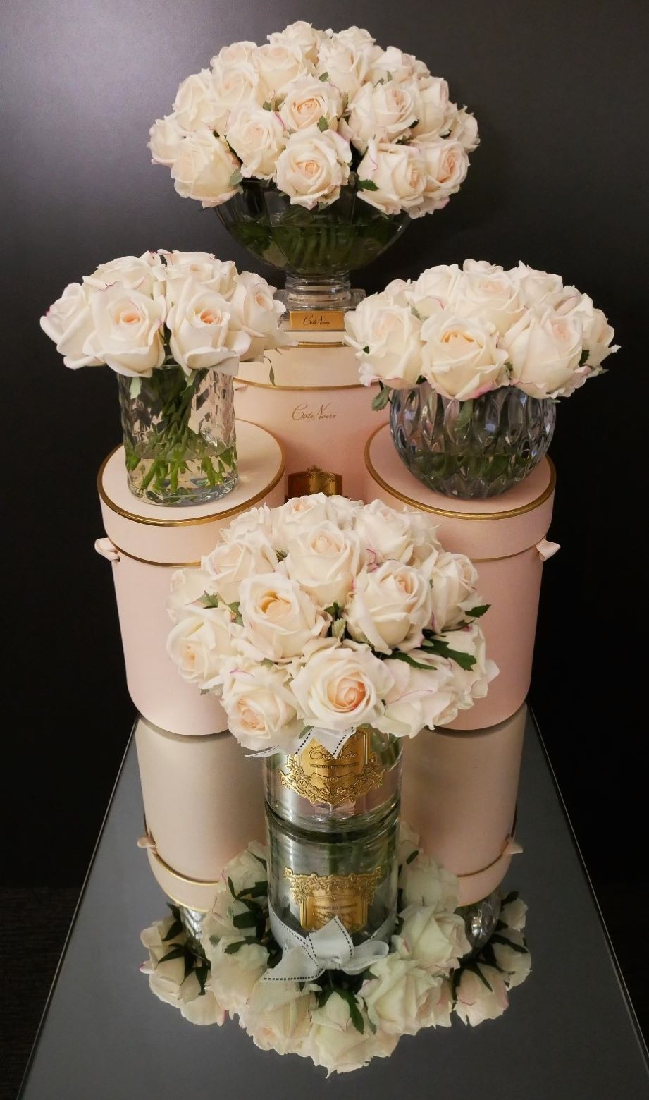 Cote Noire herringbone flower in clear glass with pink blush rose buds, styled with other Cote Noire pieces